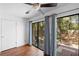 Bright bedroom featuring hardwood floors and patio access at 2808 Revere Ct, Casselberry, FL 32707