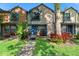 Charming townhome featuring colorful exterior, well-manicured lawn, and inviting front porch at 2808 Revere Ct, Casselberry, FL 32707