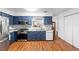 Renovated kitchen boasts ample counter space, stainless appliances, and stylish wood flooring at 2808 Revere Ct, Casselberry, FL 32707