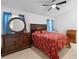 Bedroom featuring a wooden bed, dresser and nightstand with blue curtains for a warm ambiance at 2808 Revere Ct, Casselberry, FL 32707
