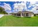 Expansive backyard showing the home's enclosed patio and a large, well-maintained lawn at 2924 Jebidiah Loop, St Cloud, FL 34772