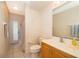 Bright bathroom featuring tile floors, a vanity with a sink, and access to the backyard through a glass door at 2924 Jebidiah Loop, St Cloud, FL 34772