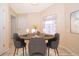 Breakfast nook with a round wood table, seating for four and a window with natural light at 2924 Jebidiah Loop, St Cloud, FL 34772
