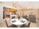 Dining room with tile flooring flows into the living room and kitchen with seating for four at a white round table at 2924 Jebidiah Loop, St Cloud, FL 34772