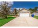 Home with two-car garage, well-maintained lawn, blue skies and American flag at 2924 Jebidiah Loop, St Cloud, FL 34772