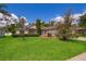 Well-maintained home with lush green lawn, mature trees, and manicured landscaping at 2924 Jebidiah Loop, St Cloud, FL 34772