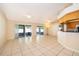 Bright living room with tile flooring, ceiling fans, and sliding glass doors to screened patio at 2924 Jebidiah Loop, St Cloud, FL 34772