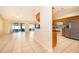 Open living room featuring tile floors, sliding doors to the patio, and adjacent kitchen area at 2924 Jebidiah Loop, St Cloud, FL 34772