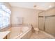Bright bathroom includes a large soaking tub, shower, and tiled floor at 2924 Jebidiah Loop, St Cloud, FL 34772