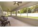 Enclosed patio with ceiling fans, multiple windows to the backyard, and outdoor seating, perfect for enjoying the outdoors at 2924 Jebidiah Loop, St Cloud, FL 34772