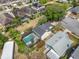 Overhead view of a house with a pool, surrounded by green landscape and other houses at 3001 Little Cypress Cv, Winter Park, FL 32792