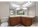 Bathroom featuring double vanity sinks and large mirrors with decorative lighting at 3001 Little Cypress Cv, Winter Park, FL 32792