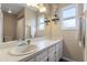 Bright bathroom featuring double sinks, a large mirror, and natural light at 3001 Little Cypress Cv, Winter Park, FL 32792