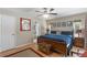 Comfortable bedroom with hardwood floors, a ceiling fan, and a view of the ensuite bathroom at 3001 Little Cypress Cv, Winter Park, FL 32792