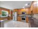 Spacious kitchen with stainless steel appliances, ample counter space, and a built-in desk area at 3001 Little Cypress Cv, Winter Park, FL 32792