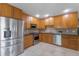 Modern kitchen featuring stainless steel appliances, wooden cabinets, and stylish countertops at 3001 Little Cypress Cv, Winter Park, FL 32792