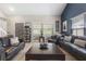 Spacious living room featuring comfortable sofas, a stylish coffee table, and natural light at 3001 Little Cypress Cv, Winter Park, FL 32792