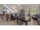 Bright living area with tile flooring, a comfortable sofa, and a staircase in the background at 3001 Little Cypress Cv, Winter Park, FL 32792