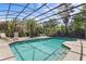 Tranquil screened pool surrounded by lush foliage for ultimate backyard privacy at 3001 Little Cypress Cv, Winter Park, FL 32792