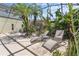 Outdoor pool area featuring sun loungers, a table, a grill, and lush landscaping at 3001 Little Cypress Cv, Winter Park, FL 32792