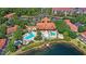 This aerial view captures the community pool and lake front location at 3064 Yellow Lantana Ln, Kissimmee, FL 34747