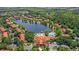An aerial view showcases the community's layout, lake, and resort-style pool area at 3064 Yellow Lantana Ln, Kissimmee, FL 34747