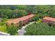 Aerial view of colorful townhomes nestled in a lush, wooded community at 3064 Yellow Lantana Ln, Kissimmee, FL 34747