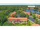 Aerial view of residences with community amenities including a lake and pool at 3064 Yellow Lantana Ln, Kissimmee, FL 34747