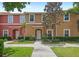 Charming townhome featuring colorful facade, well-maintained landscaping, and inviting entryway at 3064 Yellow Lantana Ln, Kissimmee, FL 34747