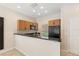 Open kitchen with black appliances and view to the back patio at 3064 Yellow Lantana Ln, Kissimmee, FL 34747