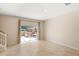 Spacious living room featuring tile floors and a sliding glass door to the patio with jacuzzi at 3064 Yellow Lantana Ln, Kissimmee, FL 34747
