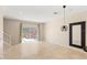 Living room featuring tile floors and a sliding glass door to the patio with a jacuzzi at 3064 Yellow Lantana Ln, Kissimmee, FL 34747