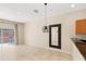 Bright living room featuring tile floors and a sliding glass door to the patio at 3064 Yellow Lantana Ln, Kissimmee, FL 34747