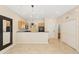 Bright living room with tile flooring, a modern pendant light and easy kitchen access at 3064 Yellow Lantana Ln, Kissimmee, FL 34747