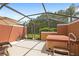 Enclosed back patio with a hot tub and lounge chair at 3064 Yellow Lantana Ln, Kissimmee, FL 34747