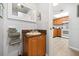 Vanity with single sink, mirror, towels, and access to the kitchen at 3118 Magic Kingdom Ct, Kissimmee, FL 34746