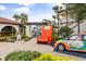 Grand entrance to Fantasy World Resort with a giant chair, themed vehicle, and lush landscaping at 3118 Magic Kingdom Ct, Kissimmee, FL 34746
