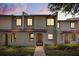 Charming townhome featuring a red-tile roof, arched entryway, and lush landscaping at 3118 Magic Kingdom Ct, Kissimmee, FL 34746