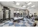 Bright gym with treadmills, ellipticals, weight machines, and free weights for residents at 3118 Magic Kingdom Ct, Kissimmee, FL 34746