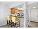Cozy kitchen featuring wood cabinets, a breakfast bar with seating, and modern appliances at 3118 Magic Kingdom Ct, Kissimmee, FL 34746