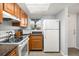 Bright kitchen with stainless steel appliances, wood cabinets, and a window with natural light at 3118 Magic Kingdom Ct, Kissimmee, FL 34746