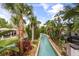 Picturesque lazy river winding through tropical plants and palm trees, perfect for relaxation at 3118 Magic Kingdom Ct, Kissimmee, FL 34746