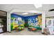 Fun ' room with colorful mural, small tables and seating next to frozen yogurt machines at 3118 Magic Kingdom Ct, Kissimmee, FL 34746