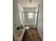 Modest bathroom featuring a toilet, sink, and shower with glass doors at 31647 Mount Plymouth Loop, Sorrento, FL 32776