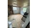 Shows the bedroom with a window, and the ceiling and walls in need of repair at 31647 Mount Plymouth Loop, Sorrento, FL 32776