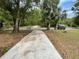 Long driveway leading to a property with ample outdoor space and landscaping potential at 31647 Mount Plymouth Loop, Sorrento, FL 32776