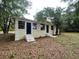 Charming single-story home featuring dual entryways, set against a backdrop of natural surroundings at 31647 Mount Plymouth Loop, Sorrento, FL 32776