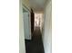 This is a hallway with damaged flooring and white walls that needs repairs at 31647 Mount Plymouth Loop, Sorrento, FL 32776