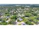 Stunning aerial view of a neighborhood with mature trees, manicured lawns, and picturesque lake views at 3332 Stonewood Ct, Orlando, FL 32806