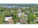 Bird's eye view highlighting a residential area featuring lush greenery, a refreshing pool, and a verdant landscape at 3332 Stonewood Ct, Orlando, FL 32806